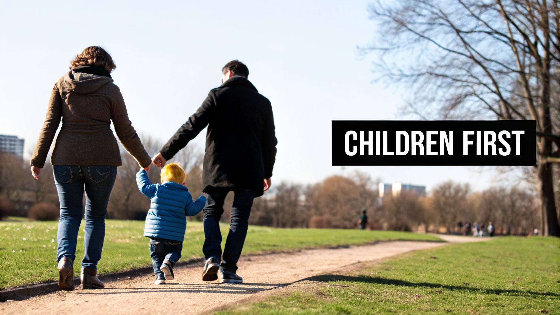 A family, mother, father, and young child, walk hand-in-hand along a park path with 'CHILDREN FIRST' text.