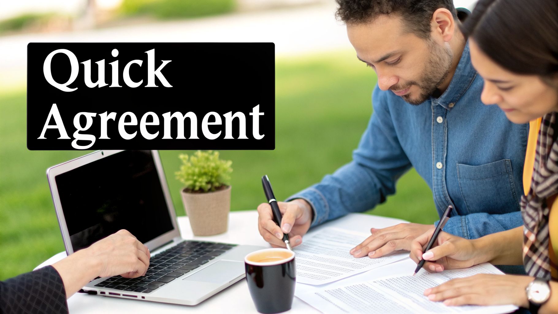 Two people signing documents at an outdoor table with a laptop, indicating a quick agreement.
