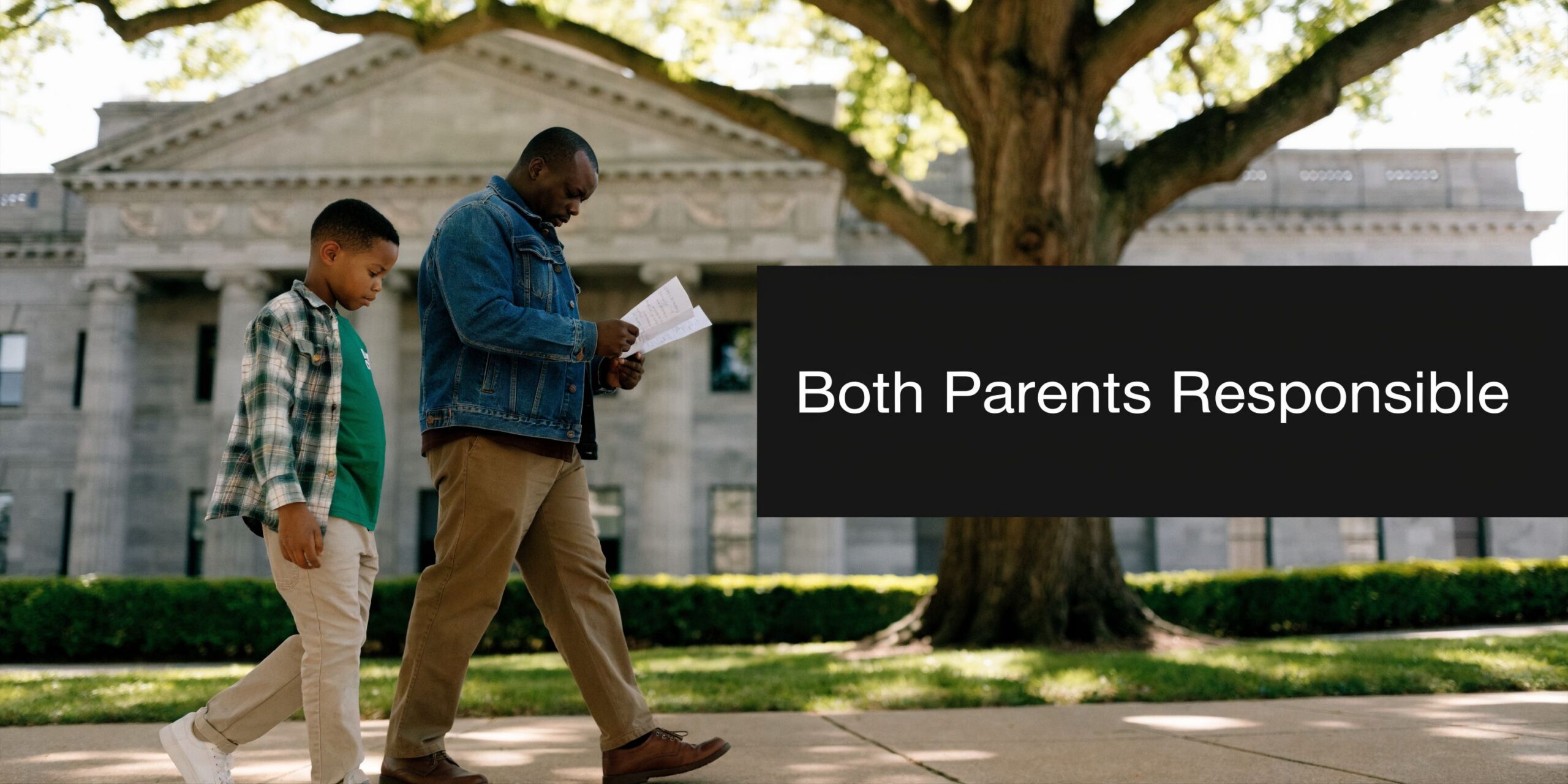 A father and son walking outside a courthouse building while reviewing legal documents together.