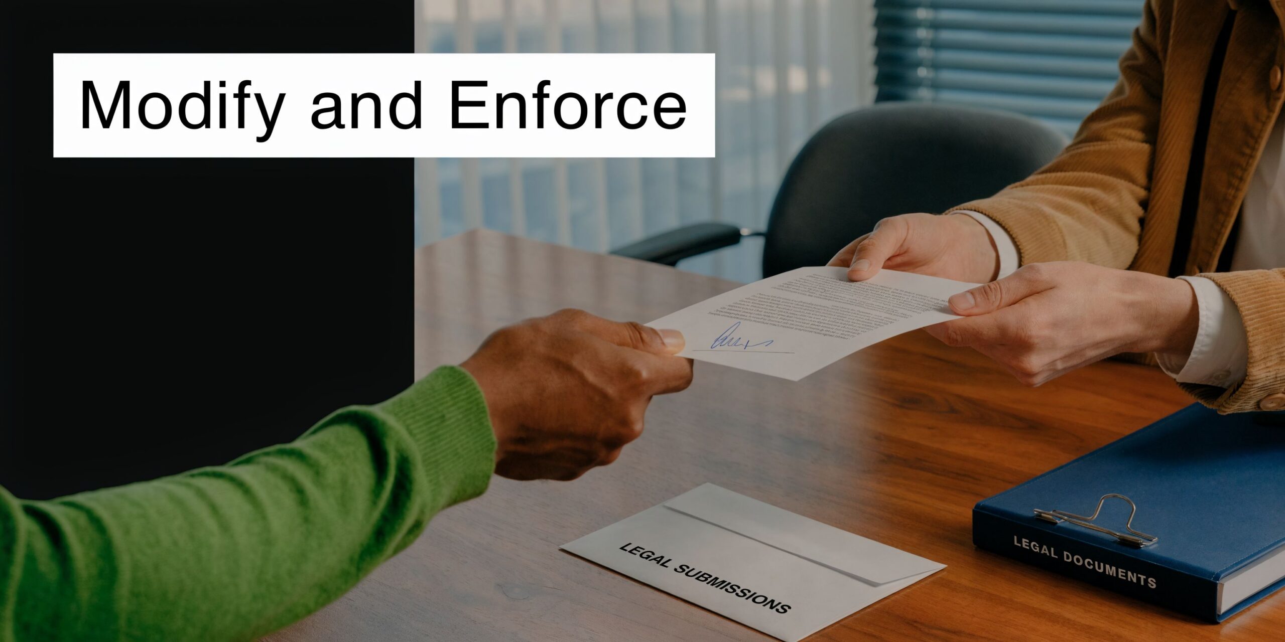 A legal professional handing a signed document to a client across a wooden desk in an office.