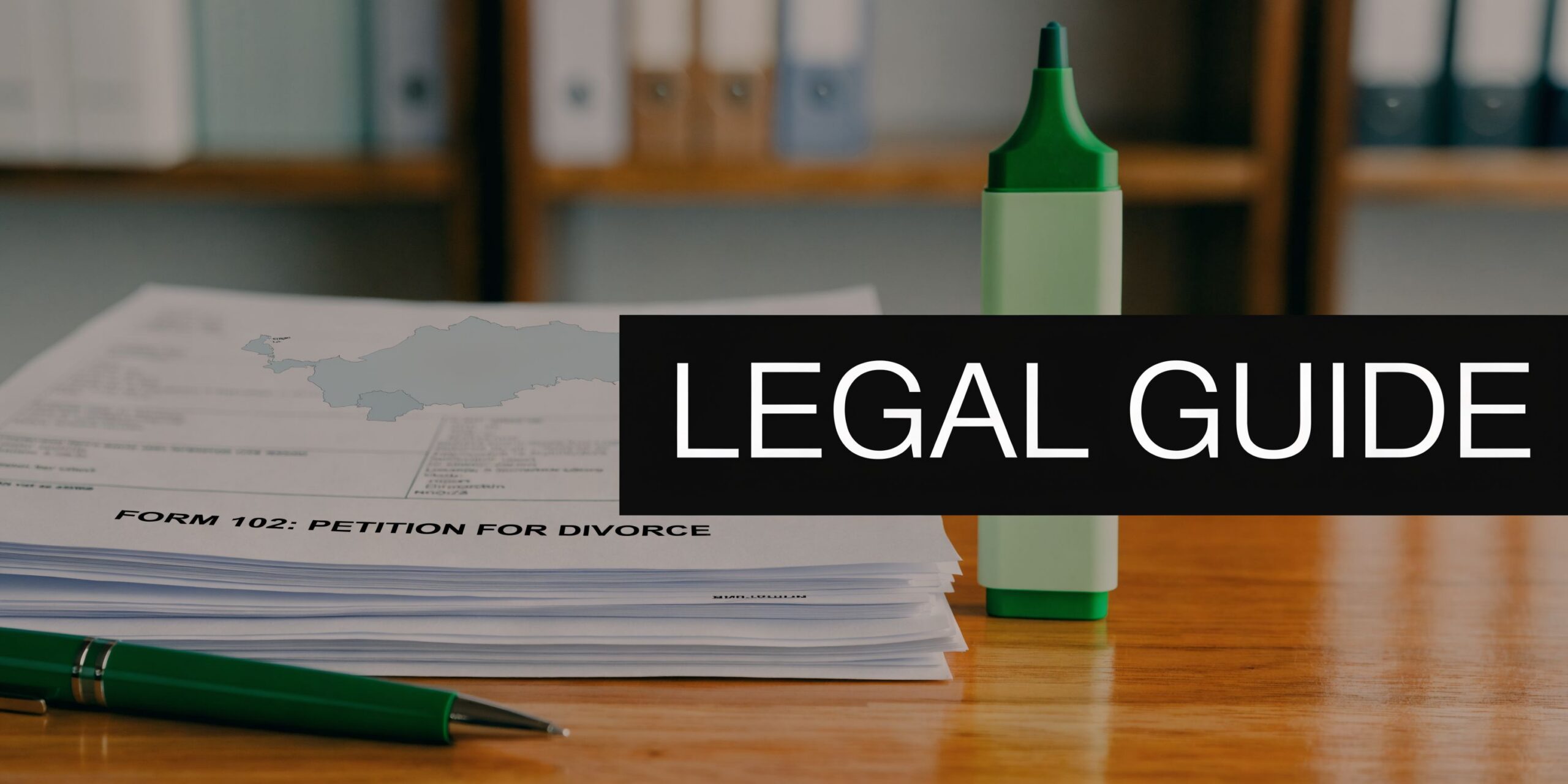 A stack of divorce petition forms on a wooden desk next to a green marker and pen.