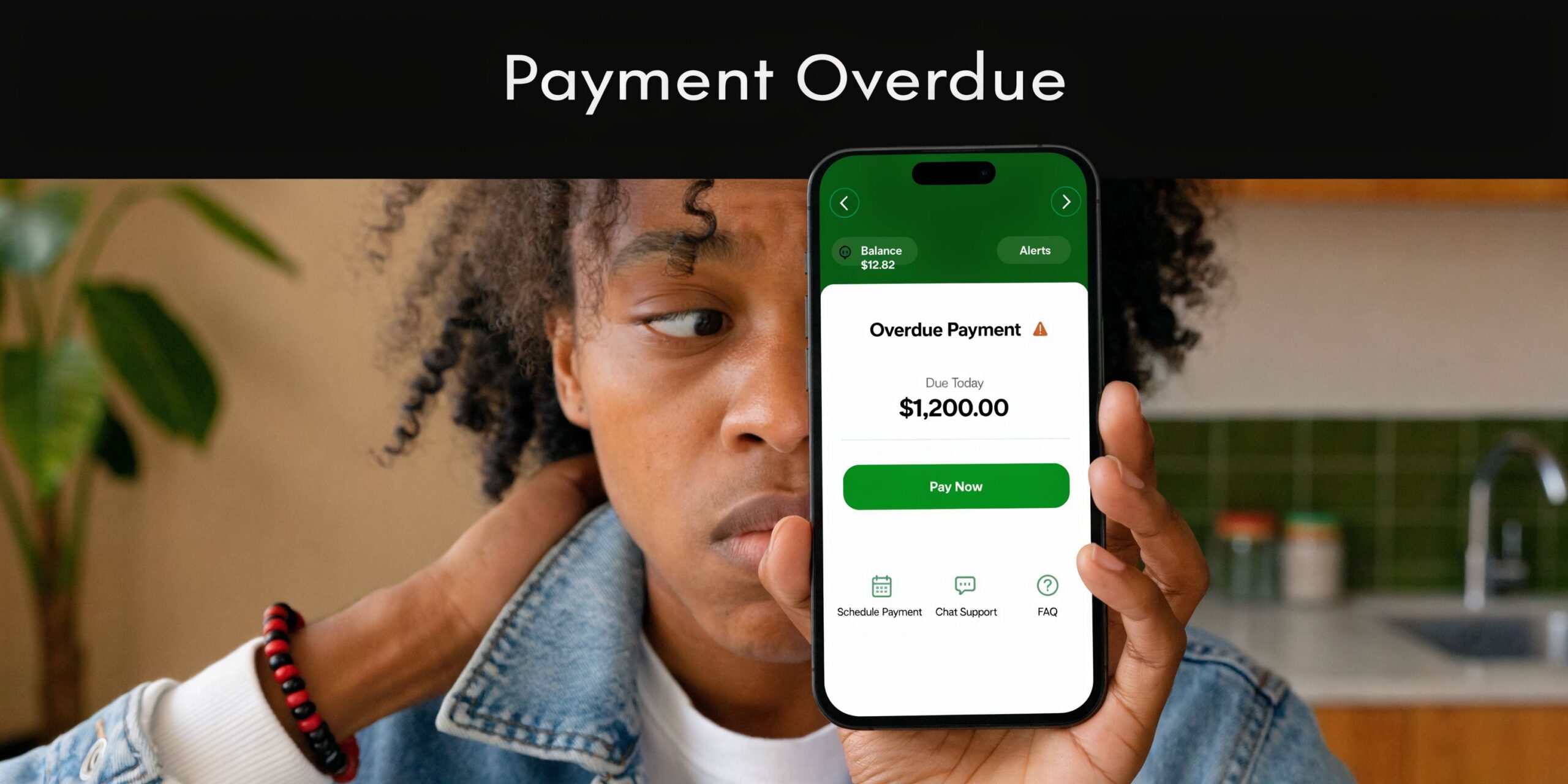 A person holding a smartphone displaying a banking app notification about an overdue payment of 1,200 dollars.