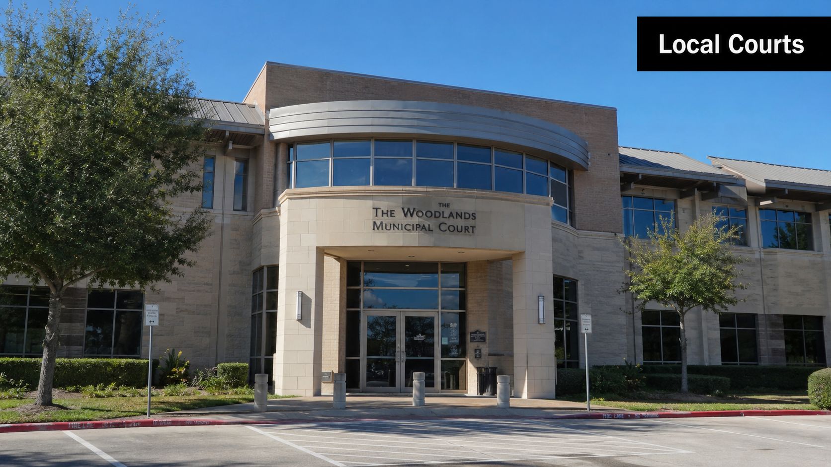 The exterior view of The Woodlands Municipal Court building on a clear and sunny day.
